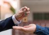 Key-is-handed-to-one-hand-to-another